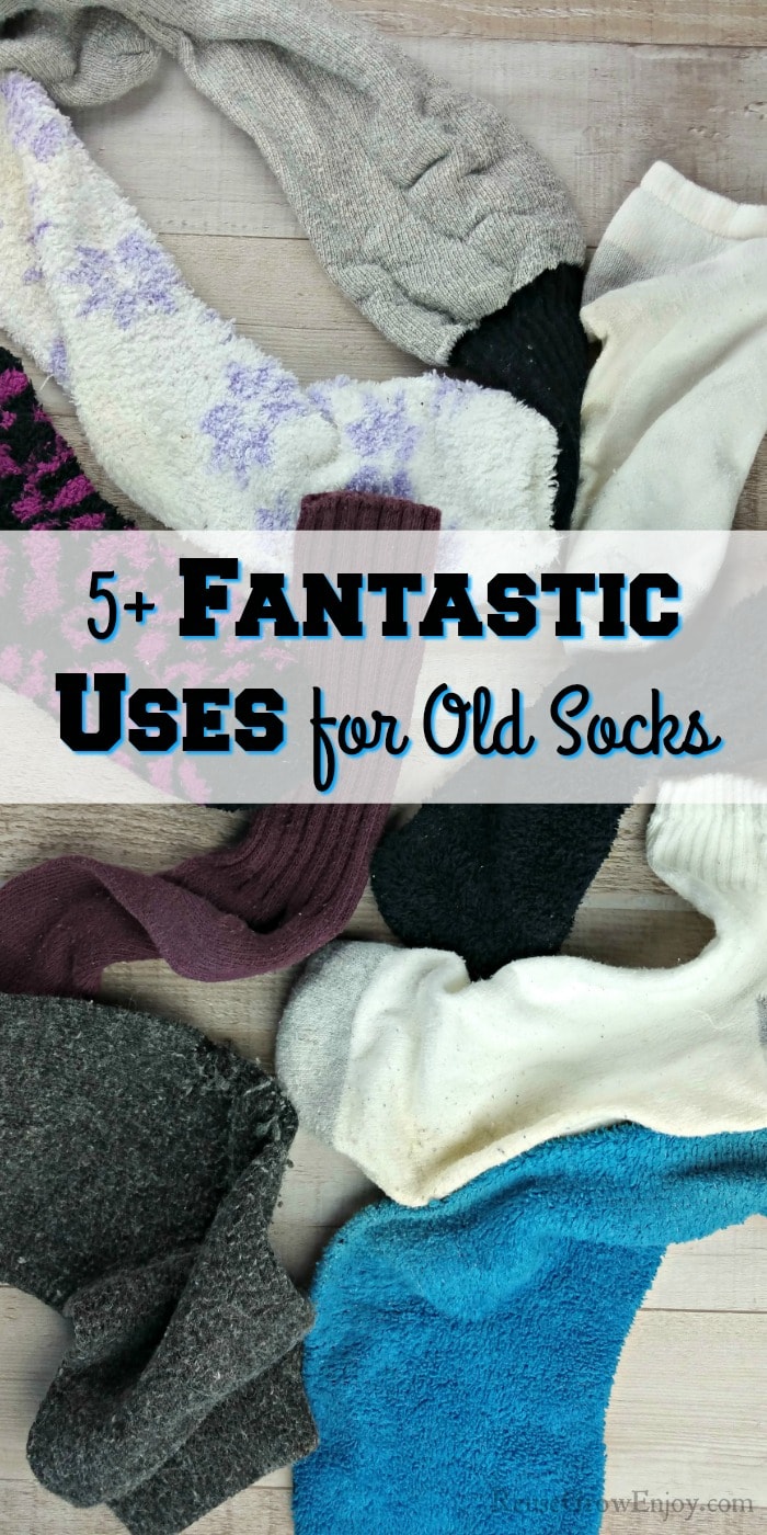 Lots of miss matched socks on wood background. Text overlay in middle that says 5+ Fantastic Uses For Old Socks