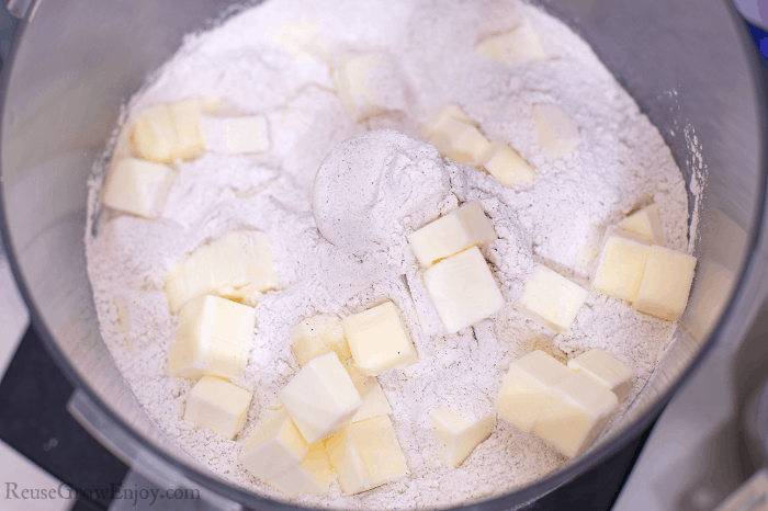 Butter cubes being added to flour mixture.