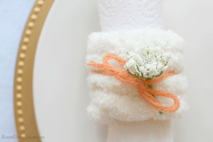 Flowers added to bow on napkin ring