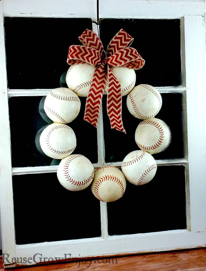 Need a new wreath for your door? If you like baseball, I have a project for you to try. It is a DIY Baseball Wreath - upcycled from old balls and a coat hanger.