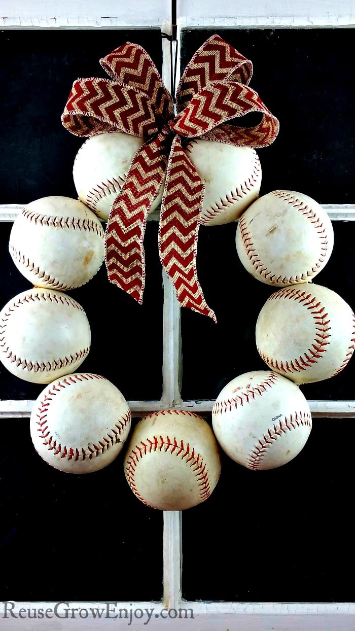 Need a new wreath for your door? If you like baseball, I have a project for you to try. It is a DIY Baseball Wreath - upcycled from old balls and a coat hanger.