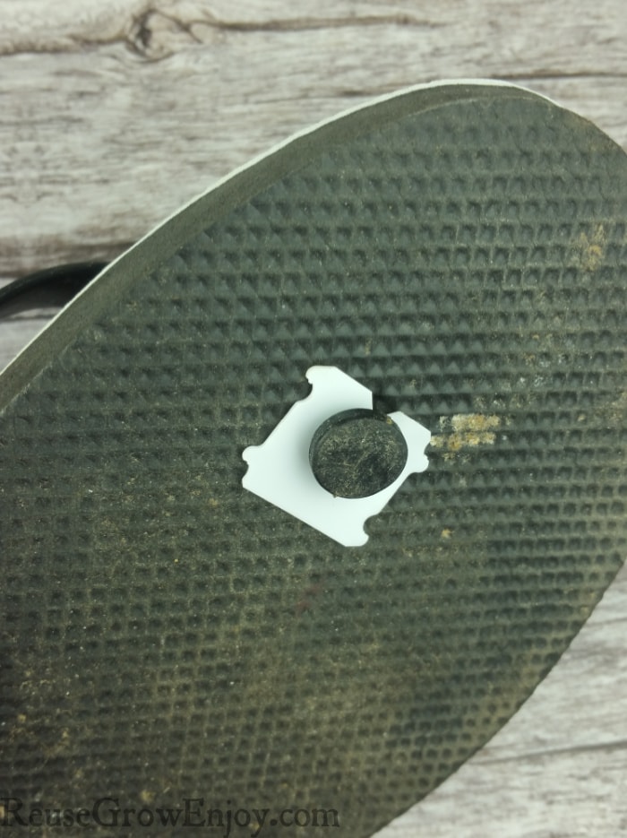 Bread clip holding bottom of flip flop strap