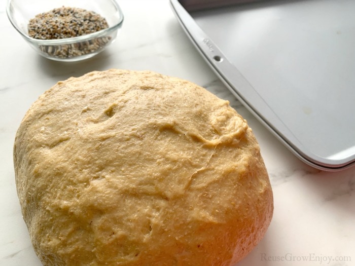 Big ball of bread dough with cookie sheet in background