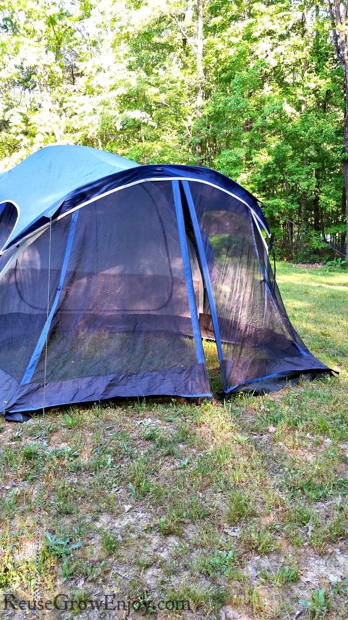 Dark blue tent set up on grass camping for free.