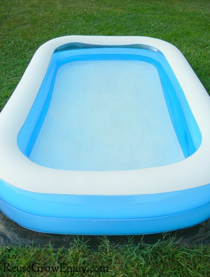 White and blue kids pool with clear clean water.