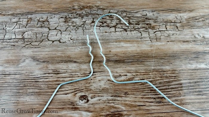 Wire coat hanger being untwisted from itself
