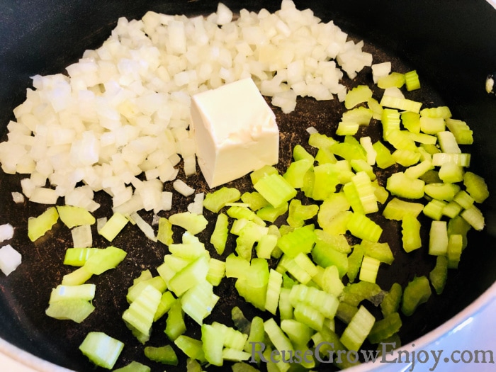Cooking onions and celery in pan with butter