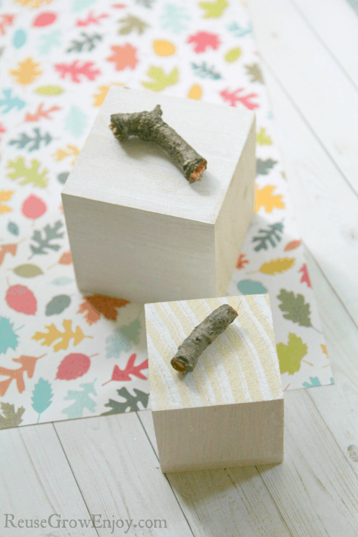 Painted white blocks with twigs laying on top.