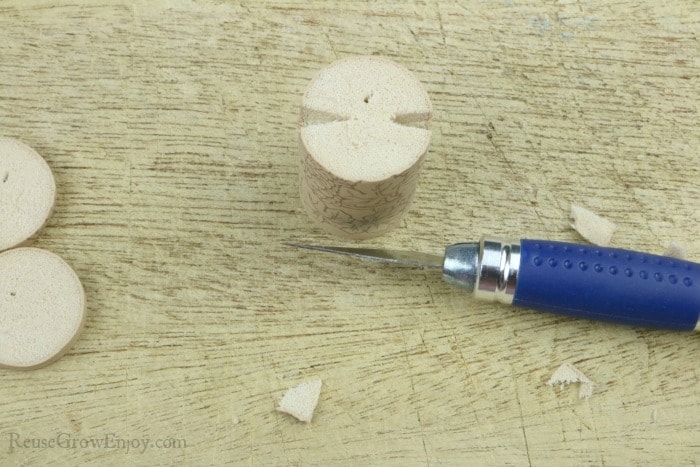 Cut two wedges out of top of cork