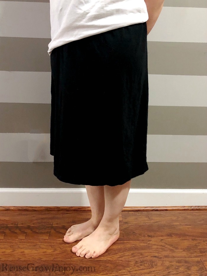 Women wearing the black dress upcycle into a skirt with a white shirt. 