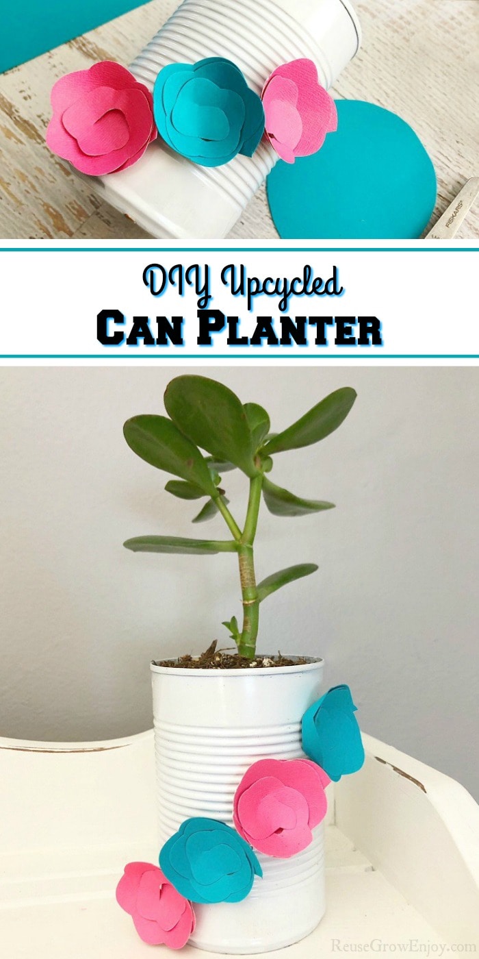 Bottom half of picture is Upcycled can planter that is white with blue and pink paper flowers on it with plant inside. Sitting on a white wood shelf. Top part is paper flowers being attached to the can. In the middle there is a text overlay that says "DIY Upcycled Can Planter".