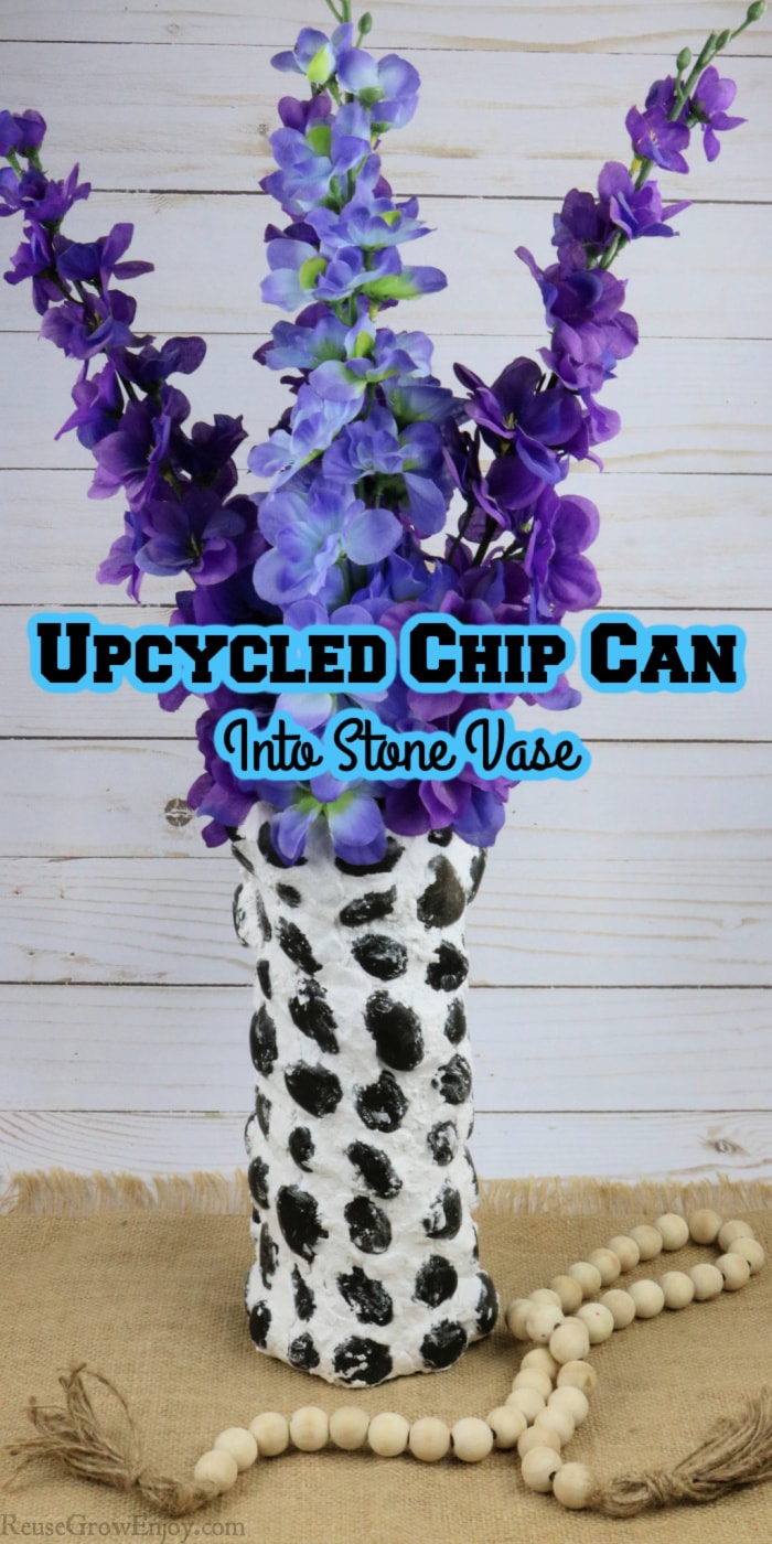 Upcycled Chip Can Into Stone Vase With purple flowers in vase and wood beads at base text overlay at the top