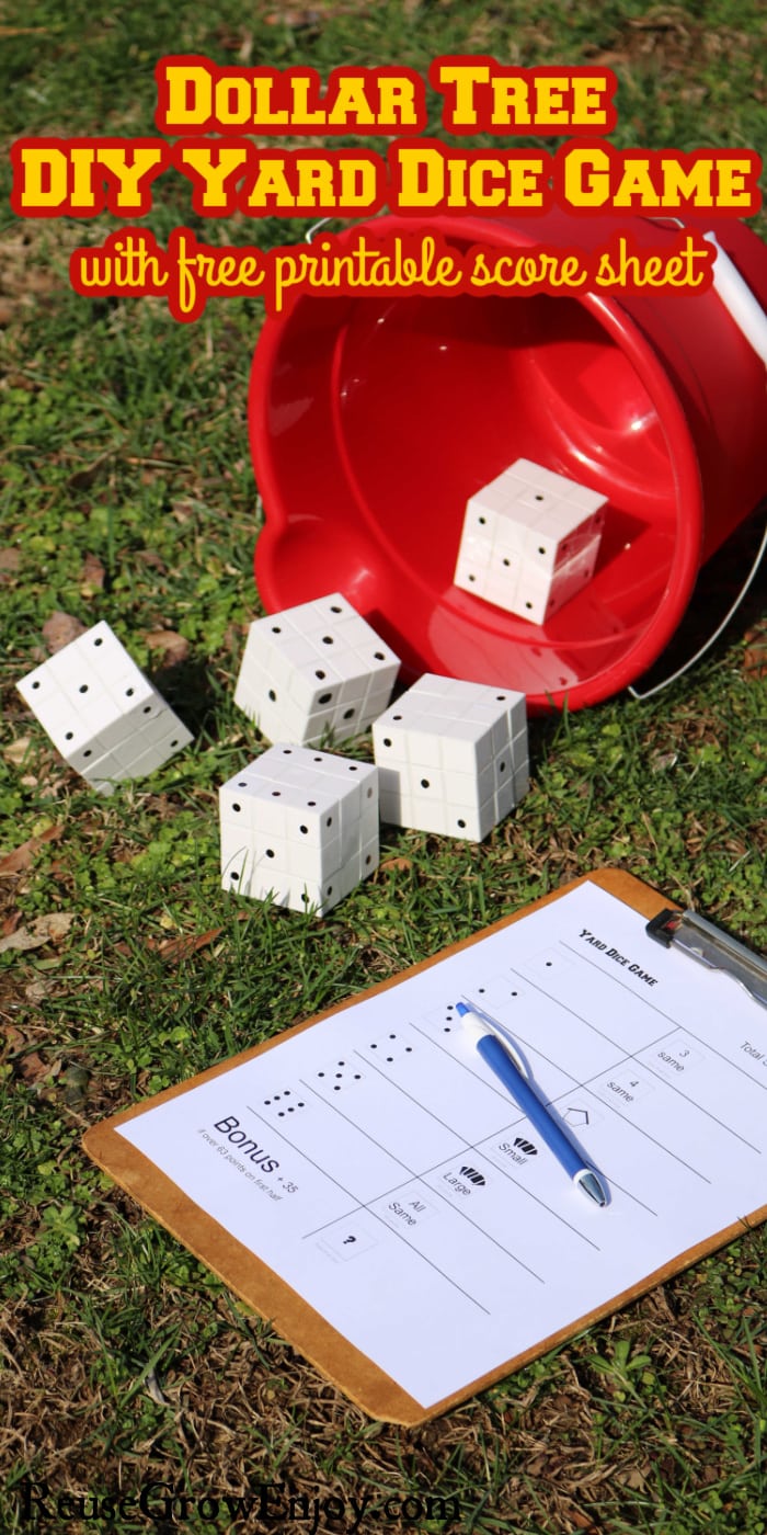 Large dice on grass with red bucket and clipboard with score sheet text overlay at top that says Dollar Tree DIY Yard Dice Game with free printable score sheet