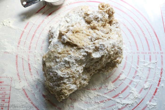 Dough on floured mat with flour dusted on dough