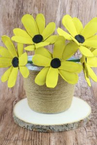 Finished black-eyed Susan flowers in metal bucket wrapped with twine