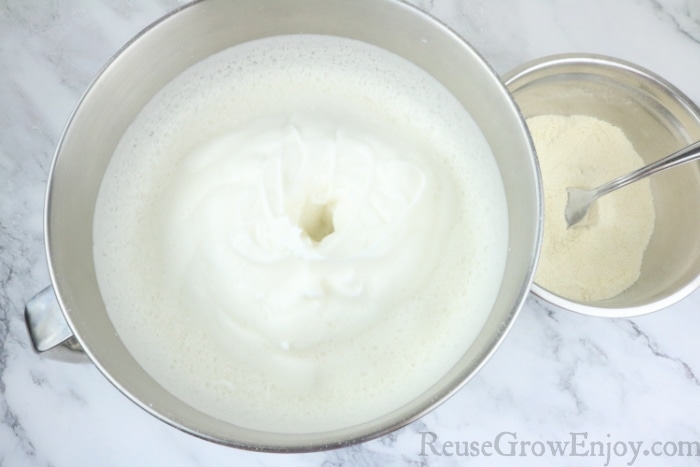 Egg whites with stiff peaks in mixing bowl