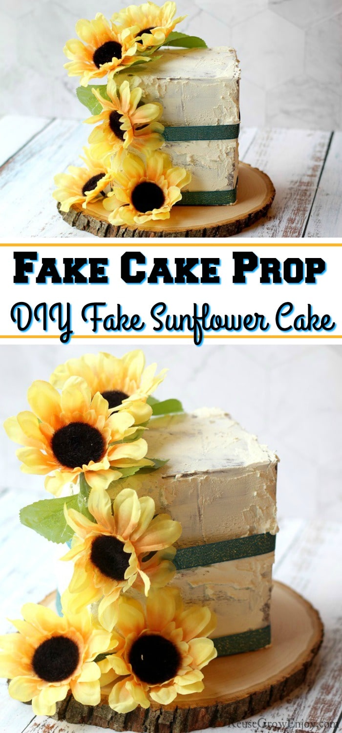 A finished fake cake prop with sunflowers and green ribbon. It is on a wood slice. Text overlay int the middle that says "Fake Cake Prop DIY Fake Sunflower Cake".