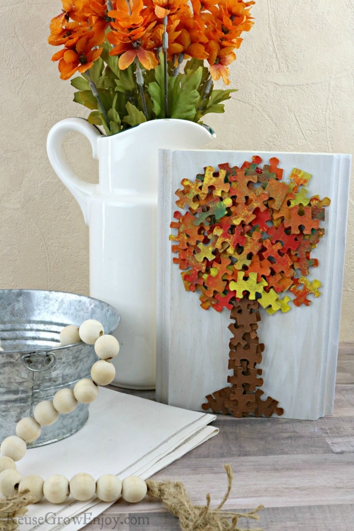 Fall home decor with fall tree made from puzzle pieces.
