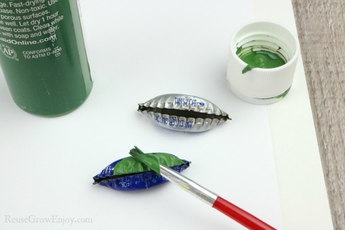 Folded caps being painted green