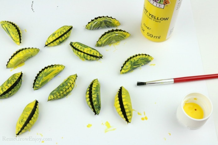 Folded caps being painted yellow