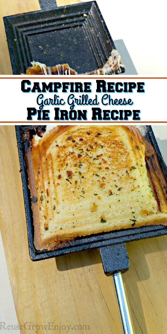 Cooked garlic grilled cheese in open pie iron laying on a board. Text overlay that says campfire recipe garlic grilled cheese pie iron recipe.