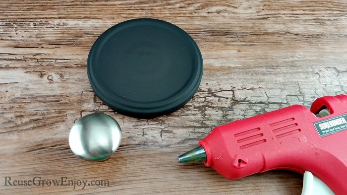 Hot glue gun, black painted jar top and stainless steel knob