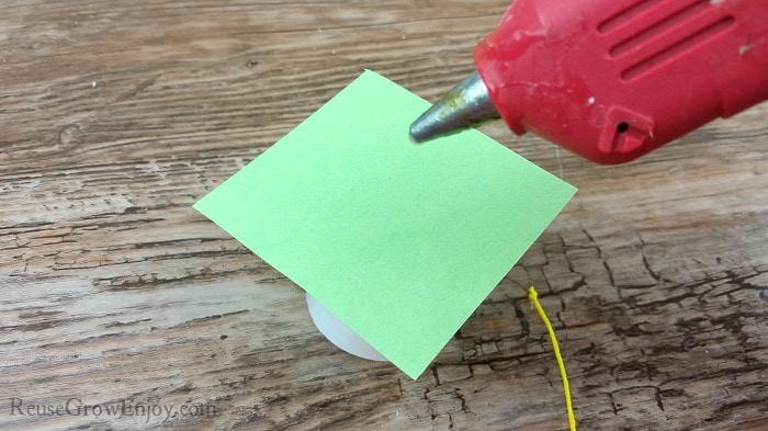 Glue string to paper.