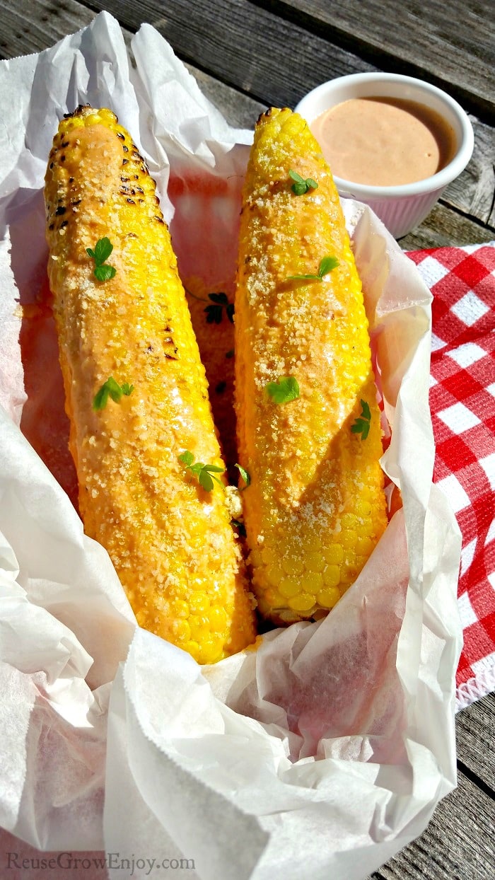 Tired of butter and salt on your corn? Hit your taste buds with this delicious Grilled Buffalo Corn On The Cob Recipe! A recipe for any cookout or camp!