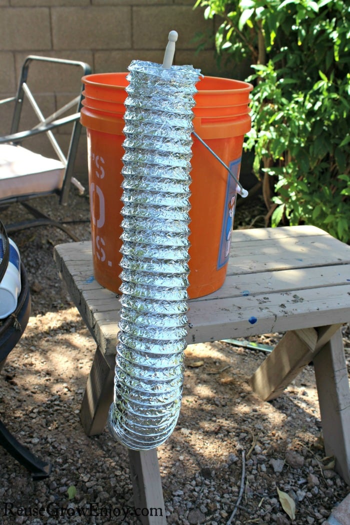 Dryer duct hanging on bucket on table