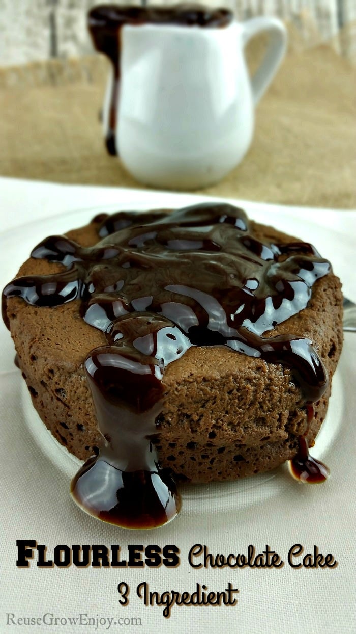 Healthy Flourless Chocolate Cake in the front with chocolate glaze in the backround.