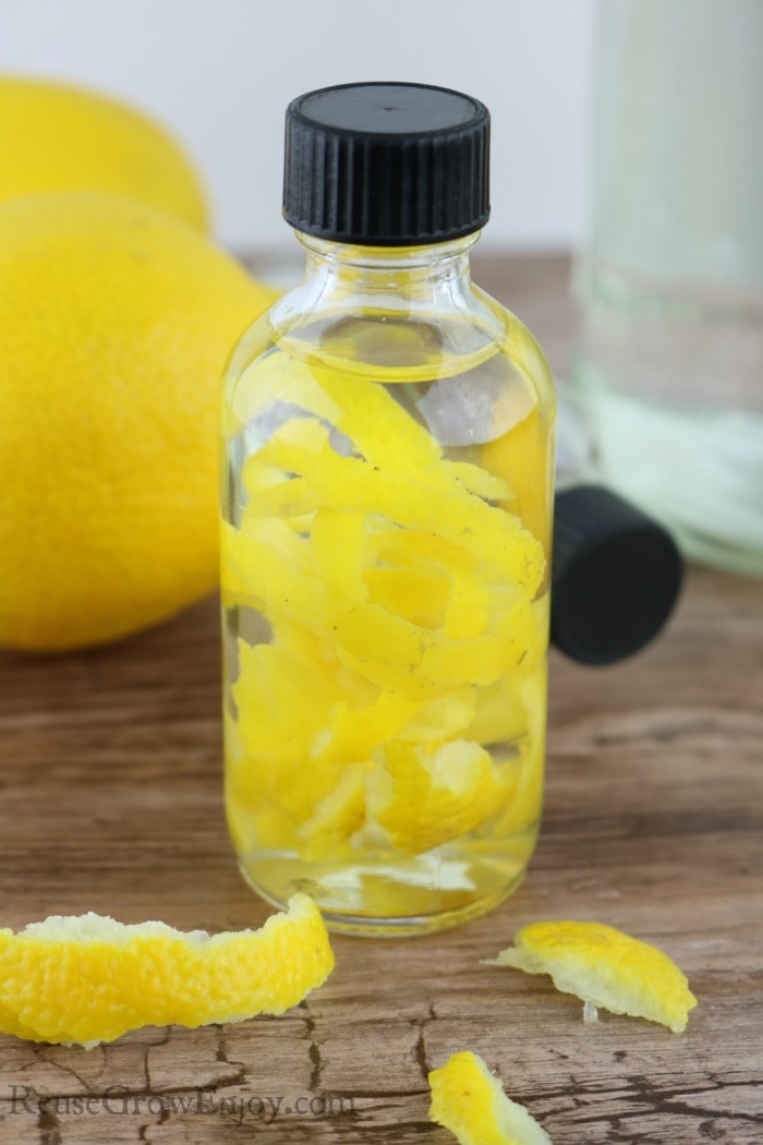 Small glass bottle of lemon extract with lemon peels inside