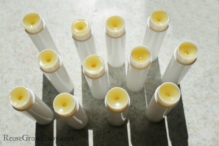 Pour your homemade peppermint lip balm into the containers and allow to cool before place lids on.