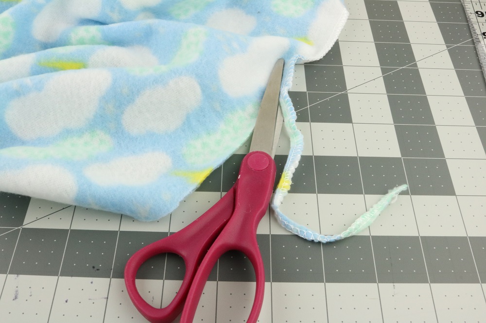 Scissors cutting the edge of the blankets off