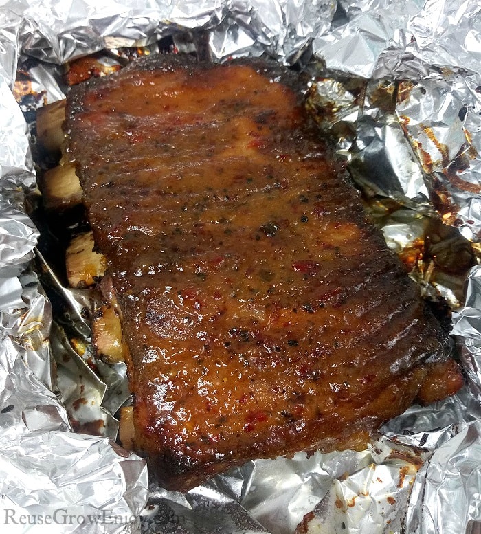 Oven Baked Ribs that are nicely glazed and laying on foil.