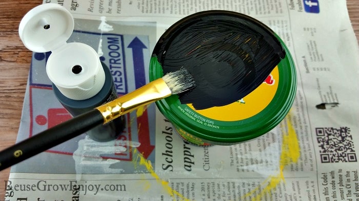 Paint bush painting jar lid black