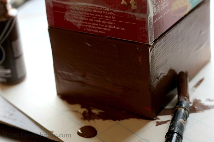 Boxes being painted brown.