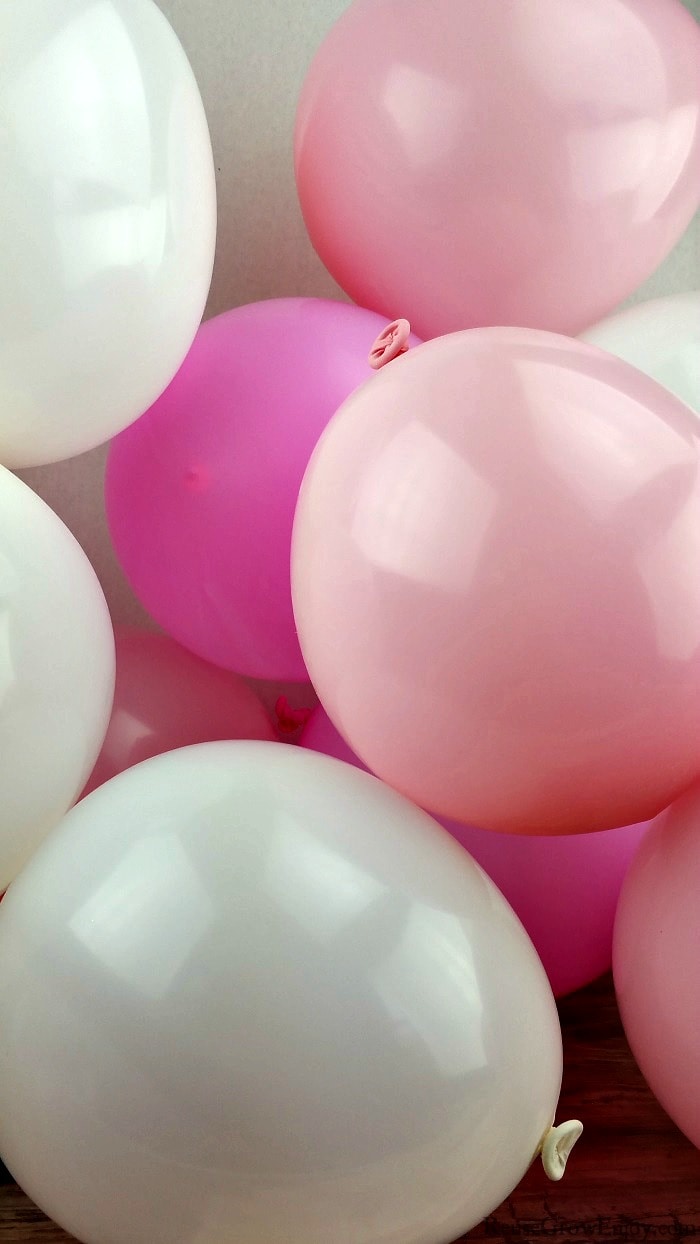 Pink and white balloons filled with air.