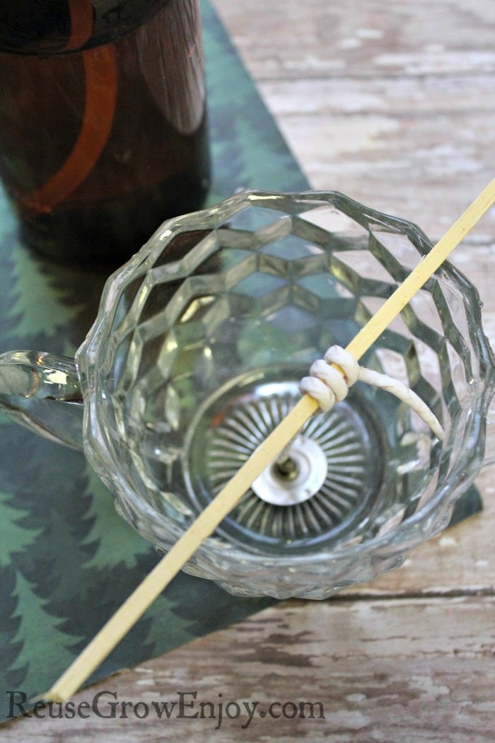 Wrap the wick around the stick and place it in the jar. Rest the stick on the top of the jar and be sure it is center.