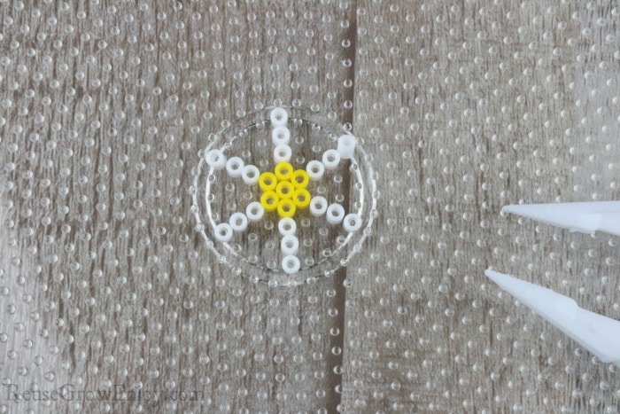 Put lines of white beads on side of yellow