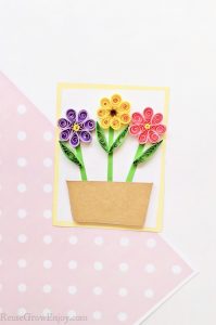 Quilled flowers on paper making a card