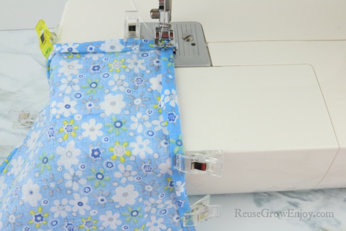 Sew down edges of fabric