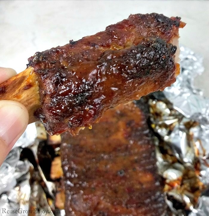 Single cooked rib being held