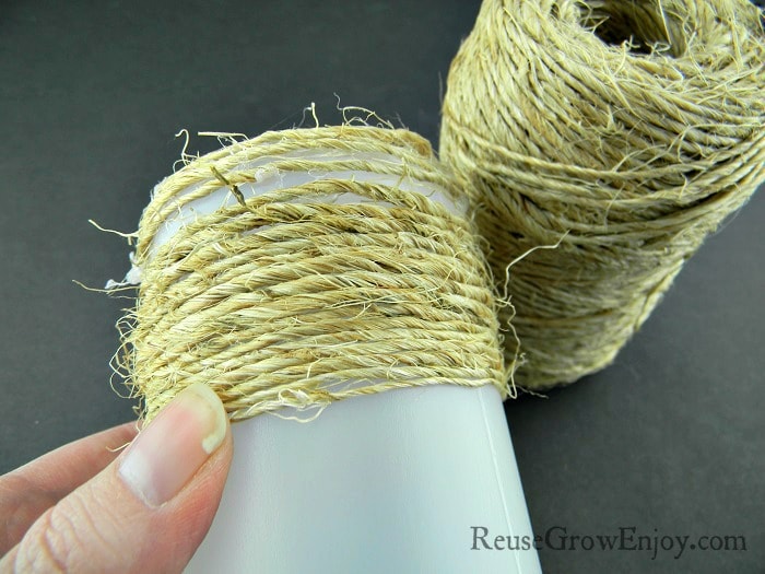 Twine wrapped about half way down a small plastic bottle