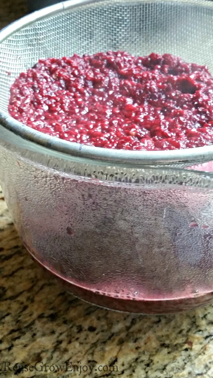 Crushed berries in strainer