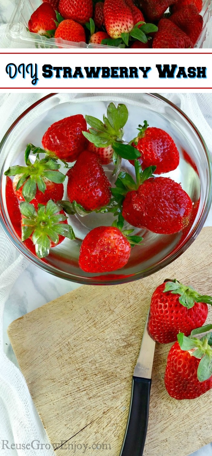 A clear glass bowl with strawberries floating in strawberry wash. Container of more strawberries in background. Cutting board with knife and berries in the front. 