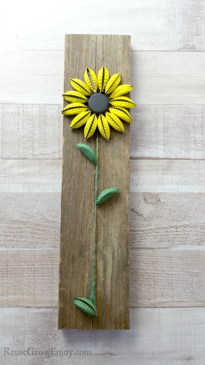 Finished bottle cap sunflower on wood