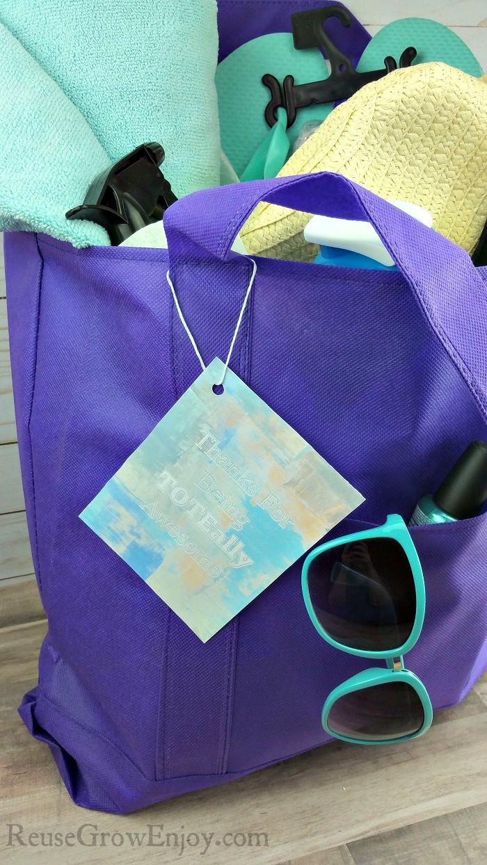 Mom gift tote bag with towel, hat, flip flops, water bottle, spray bottle and more summer items.