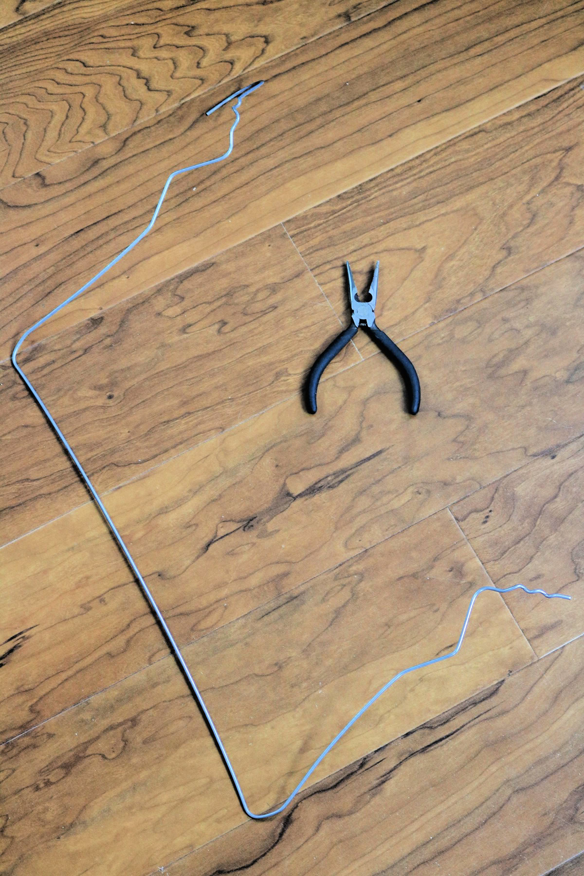 Wire and pliers for making a giant candy cane from a pool noodle.