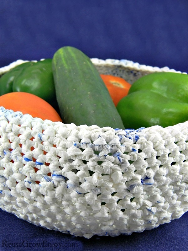 You can upcycle plastic bags into all kinds of things like jewelry, hand bags and more. Check out this idea to use upcycled bags to make a basket bowl.
