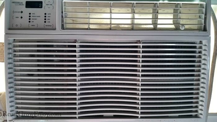 Dirty grooves on the front of a window unit AC.